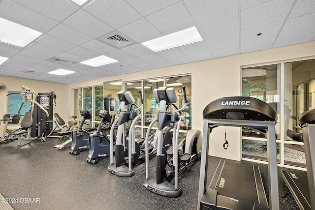 exercise room with visible vents and a drop ceiling