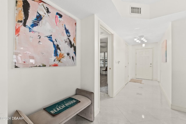 hall featuring light tile patterned floors