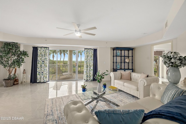 living area with ceiling fan, a wealth of natural light, and visible vents