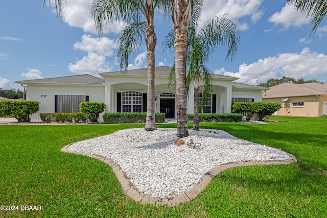 back of property featuring a lawn