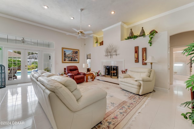 living room with light tile patterned flooring, ceiling fan, french doors, and ornamental molding