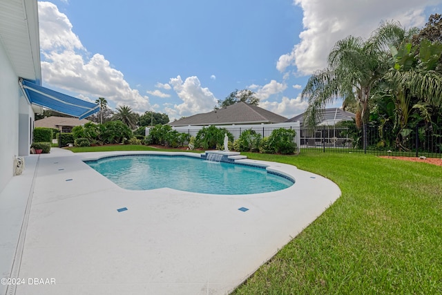 view of swimming pool with a lawn and a patio