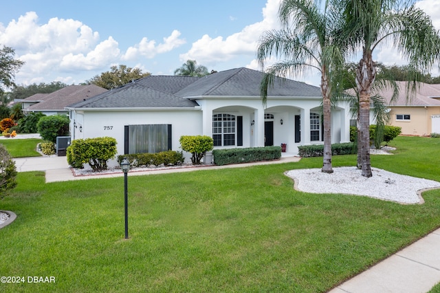 single story home featuring a front lawn