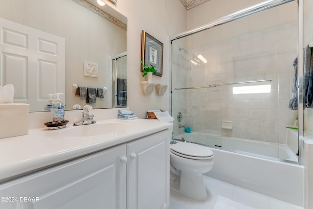 full bathroom with toilet, bath / shower combo with glass door, vanity, and tile patterned floors