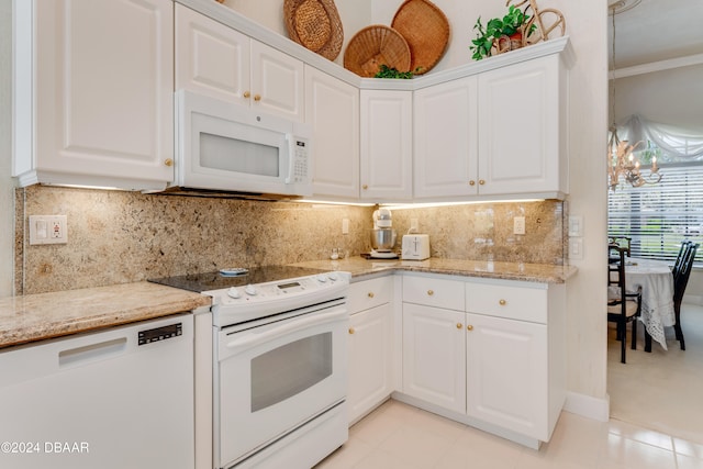 kitchen with white appliances, white cabinetry, and decorative backsplash