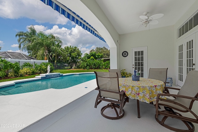 view of pool featuring ceiling fan, a lanai, and a patio area