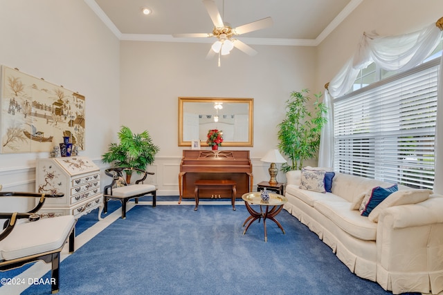 living area featuring ceiling fan, crown molding, and carpet floors