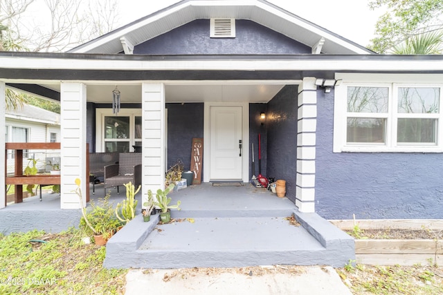 property entrance with covered porch