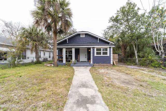 bungalow-style house featuring a front yard and central air condition unit