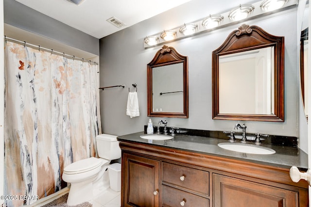 bathroom featuring toilet, vanity, and tile patterned flooring