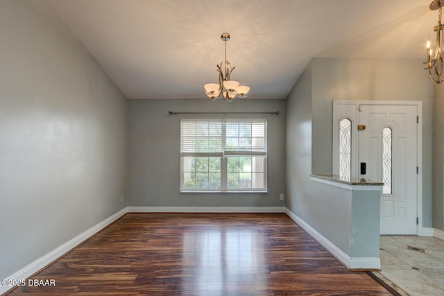 interior space with a notable chandelier and dark hardwood / wood-style flooring