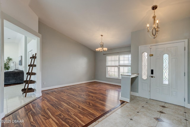 tiled foyer featuring a chandelier