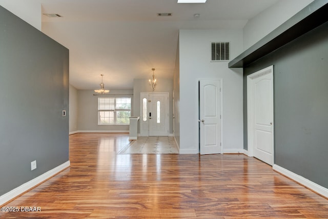 interior space featuring a chandelier and light hardwood / wood-style flooring