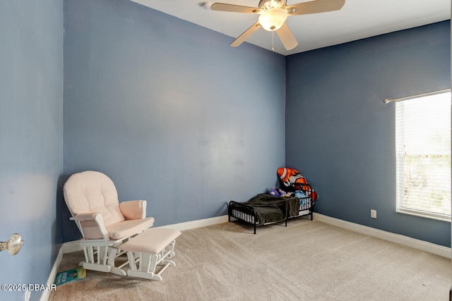 living area featuring ceiling fan and carpet flooring