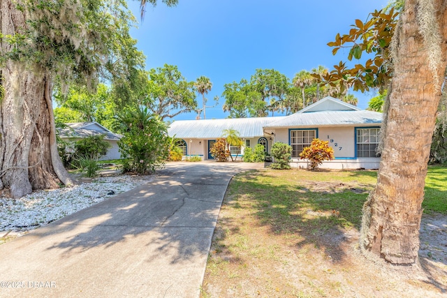 1927 Orange Tree Dr, Edgewater, FL 32141 - ranch-style house with concrete driveway, metal roof, and a front yard