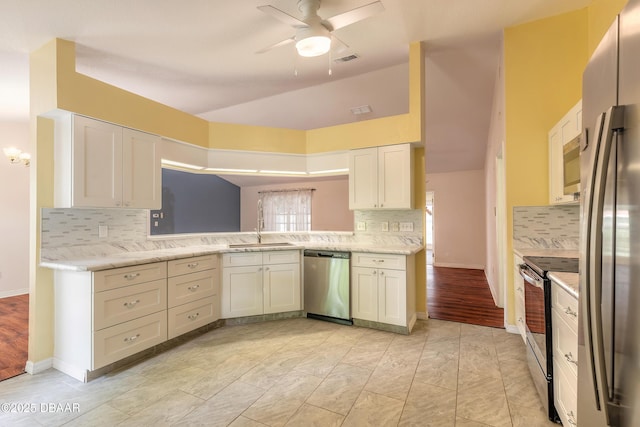 1927 Orange Tree Dr, Edgewater, FL 32141 - kitchen with stainless steel appliances, tasteful backsplash, a ceiling fan, a sink, and lofted ceiling