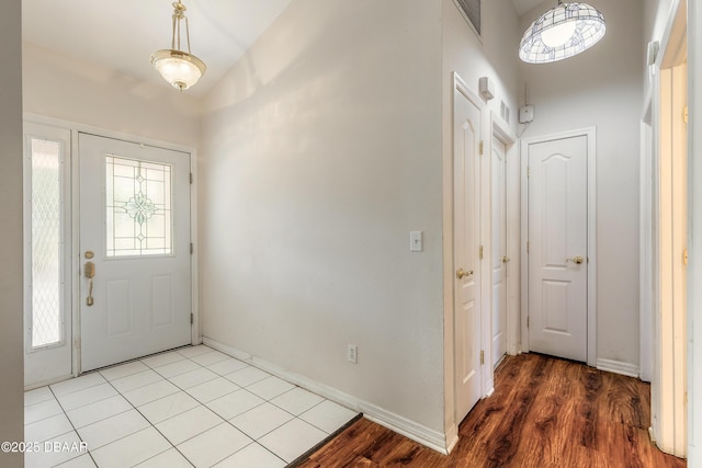 1927 Orange Tree Dr, Edgewater, FL 32141 - foyer entrance with wood finished floors, baseboards, and a high ceiling