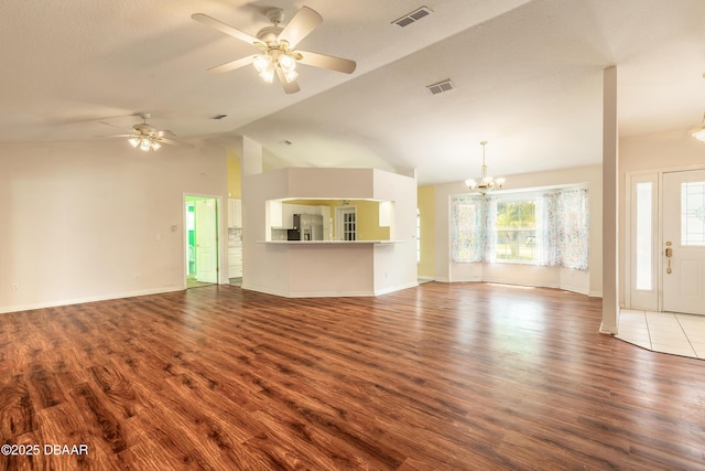 1927 Orange Tree Dr, Edgewater, FL 32141 - unfurnished living room with a chandelier, wood finished floors, ceiling fan, vaulted ceiling, and baseboards