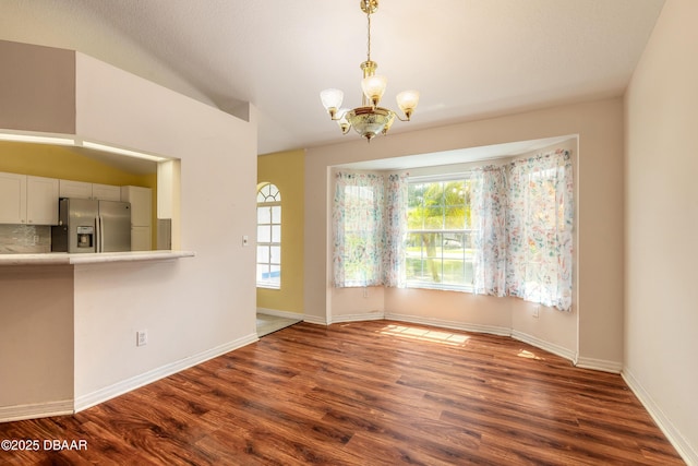 1927 Orange Tree Dr, Edgewater, FL 32141 - unfurnished dining area with a chandelier, dark wood-type flooring, and baseboards