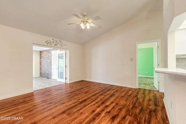 1927 Orange Tree Dr, Edgewater, FL 32141 - empty room with vaulted ceiling, wood finished floors, ceiling fan, and baseboards