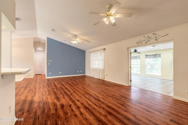 1927 Orange Tree Dr, Edgewater, FL 32141 - unfurnished living room with a ceiling fan, vaulted ceiling, wood finished floors, and baseboards