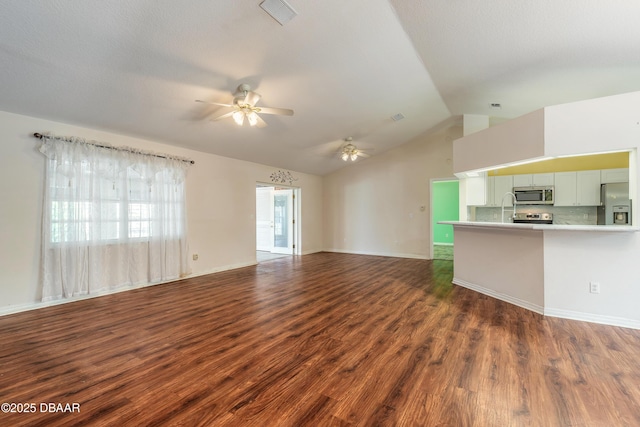 1927 Orange Tree Dr, Edgewater, FL 32141 - unfurnished living room with a ceiling fan, dark wood finished floors, vaulted ceiling, and baseboards