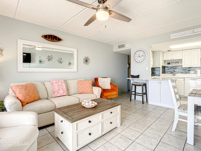 tiled living room with ceiling fan