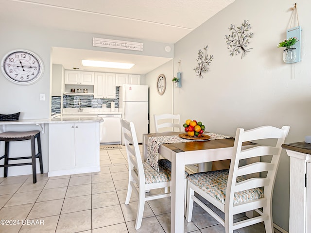 dining area with sink and light tile patterned floors