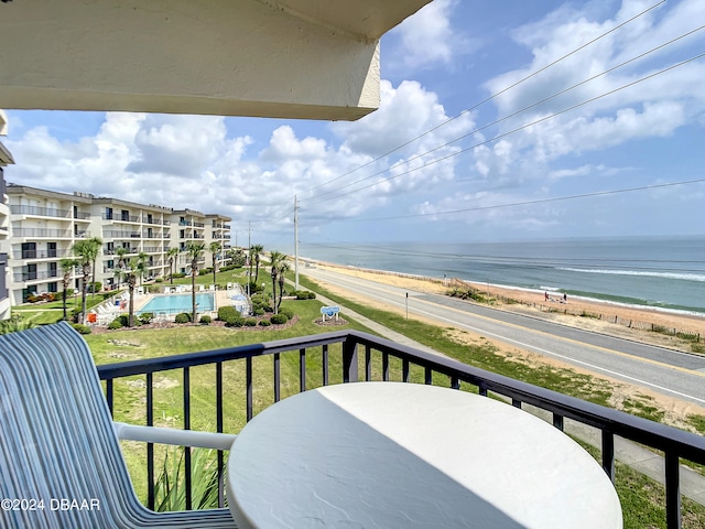 balcony with a beach view and a water view