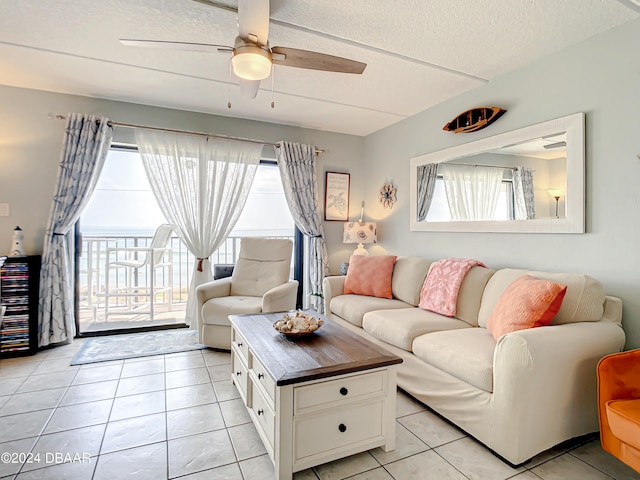 living room with ceiling fan, a healthy amount of sunlight, and light tile patterned floors