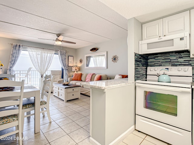 kitchen featuring kitchen peninsula, decorative backsplash, ceiling fan, white cabinetry, and white appliances