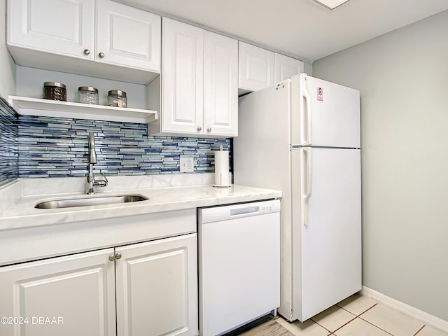 kitchen featuring light tile patterned flooring, white cabinetry, sink, tasteful backsplash, and white appliances