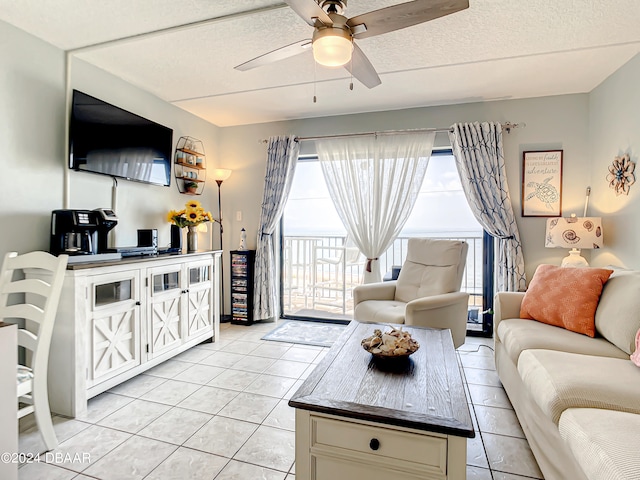 tiled living room featuring a textured ceiling and ceiling fan