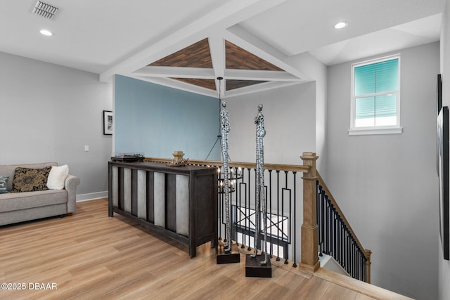 129 Seaside Pt, Flagler Beach, FL 32136 - hallway with an upstairs landing, wood finished floors, recessed lighting, and beam ceiling