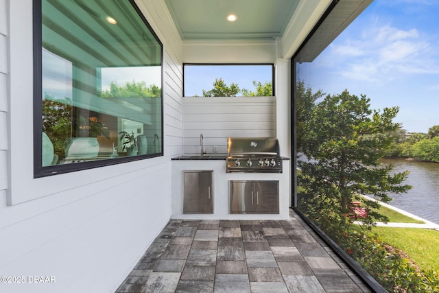 129 Seaside Pt, Flagler Beach, FL 32136 - view of patio featuring an outdoor kitchen and a water view