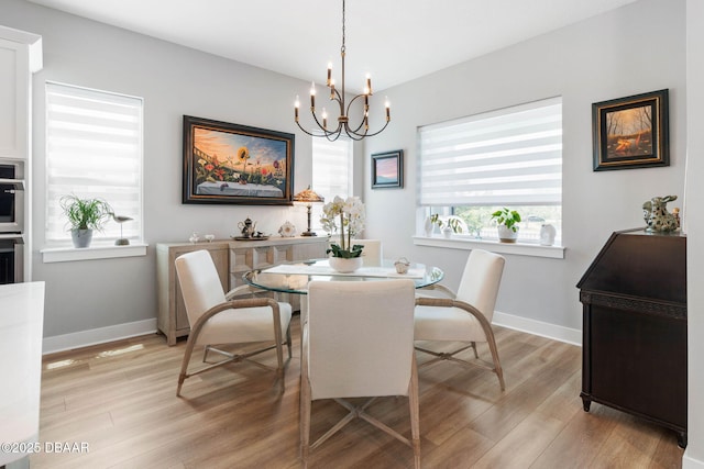 129 Seaside Pt, Flagler Beach, FL 32136 - dining room featuring a chandelier and light wood-style floors