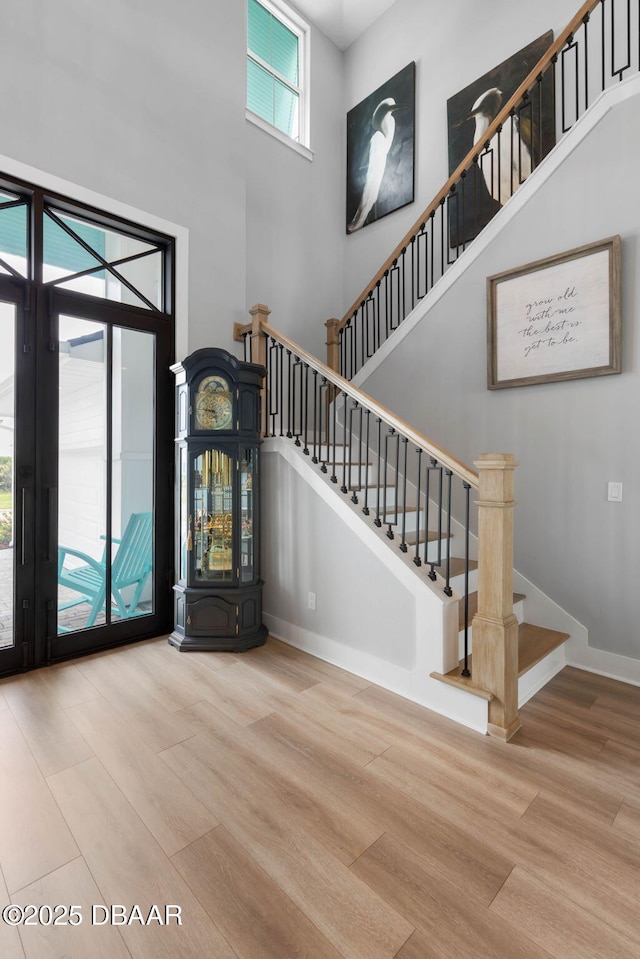 129 Seaside Pt, Flagler Beach, FL 32136 - foyer with a towering ceiling, wood finished floors, and stairway