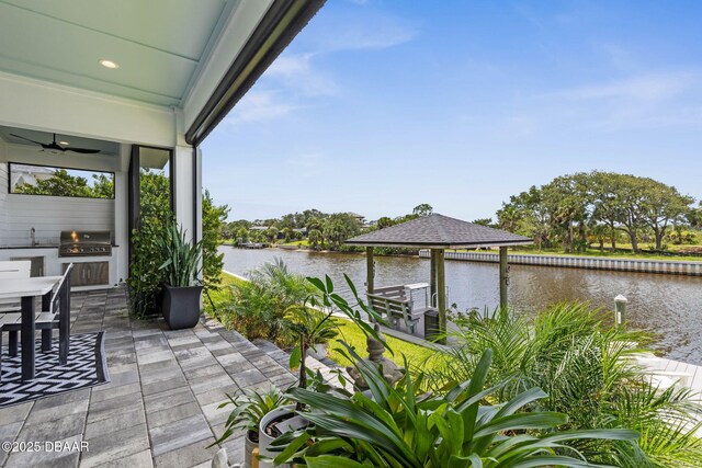 129 Seaside Pt, Flagler Beach, FL 32136 - view of patio featuring an outdoor kitchen, a water view, and ceiling fan
