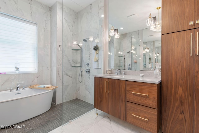 129 Seaside Pt, Flagler Beach, FL 32136 - full bath featuring a marble finish shower, a freestanding tub, vanity, tile walls, and marble finish floors