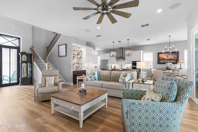 129 Seaside Pt, Flagler Beach, FL 32136 - living area with a chandelier, light wood-type flooring, a ceiling fan, recessed lighting, and stairway