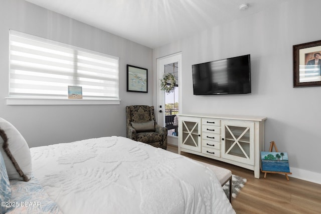129 Seaside Pt, Flagler Beach, FL 32136 - bedroom with access to outside and wood finished floors