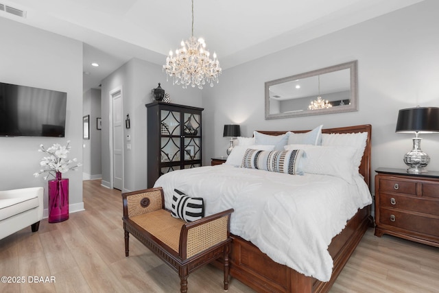 129 Seaside Pt, Flagler Beach, FL 32136 - bedroom with a chandelier, recessed lighting, and wood finished floors