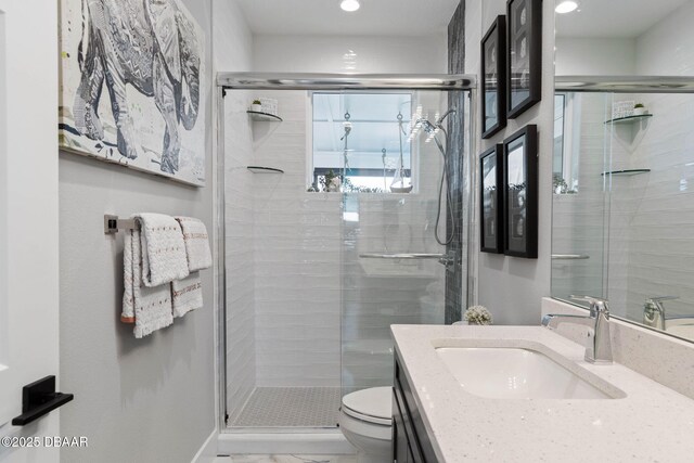 129 Seaside Pt, Flagler Beach, FL 32136 - bathroom featuring vanity, a shower stall, recessed lighting, and marble finish flooring
