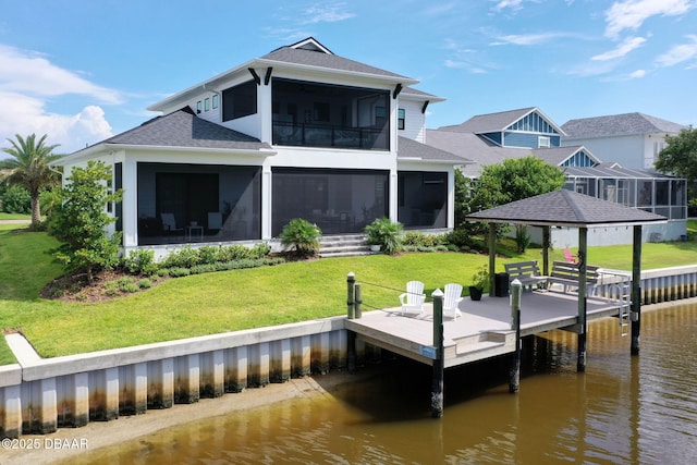 129 Seaside Pt, Flagler Beach, FL 32136 - back of property featuring a water view, a sunroom, a shingled roof, a yard, and a balcony