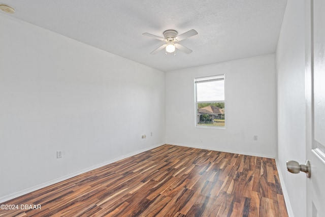 empty room with a textured ceiling, ceiling fan, and dark wood-type flooring