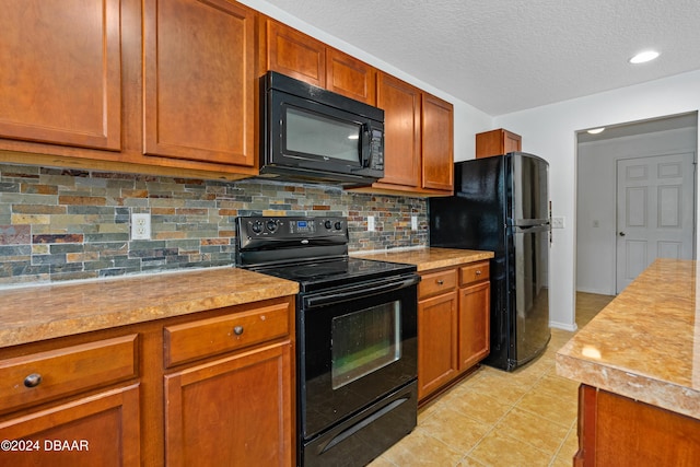 kitchen featuring black appliances, light tile patterned floors, backsplash, and a textured ceiling