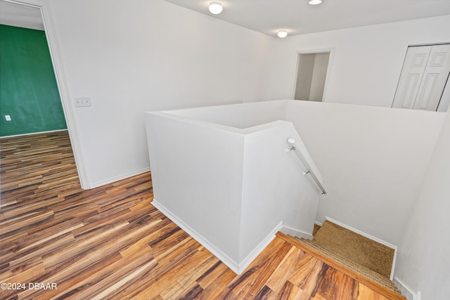 stairs with wood-type flooring