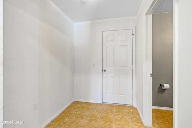 hall featuring a textured ceiling