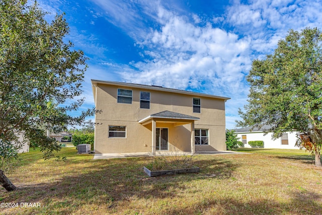 back of property featuring a lawn, central AC, and a patio