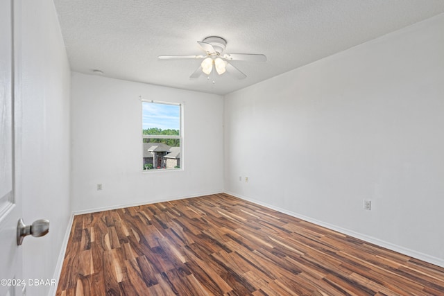 empty room with a textured ceiling, ceiling fan, and dark wood-type flooring